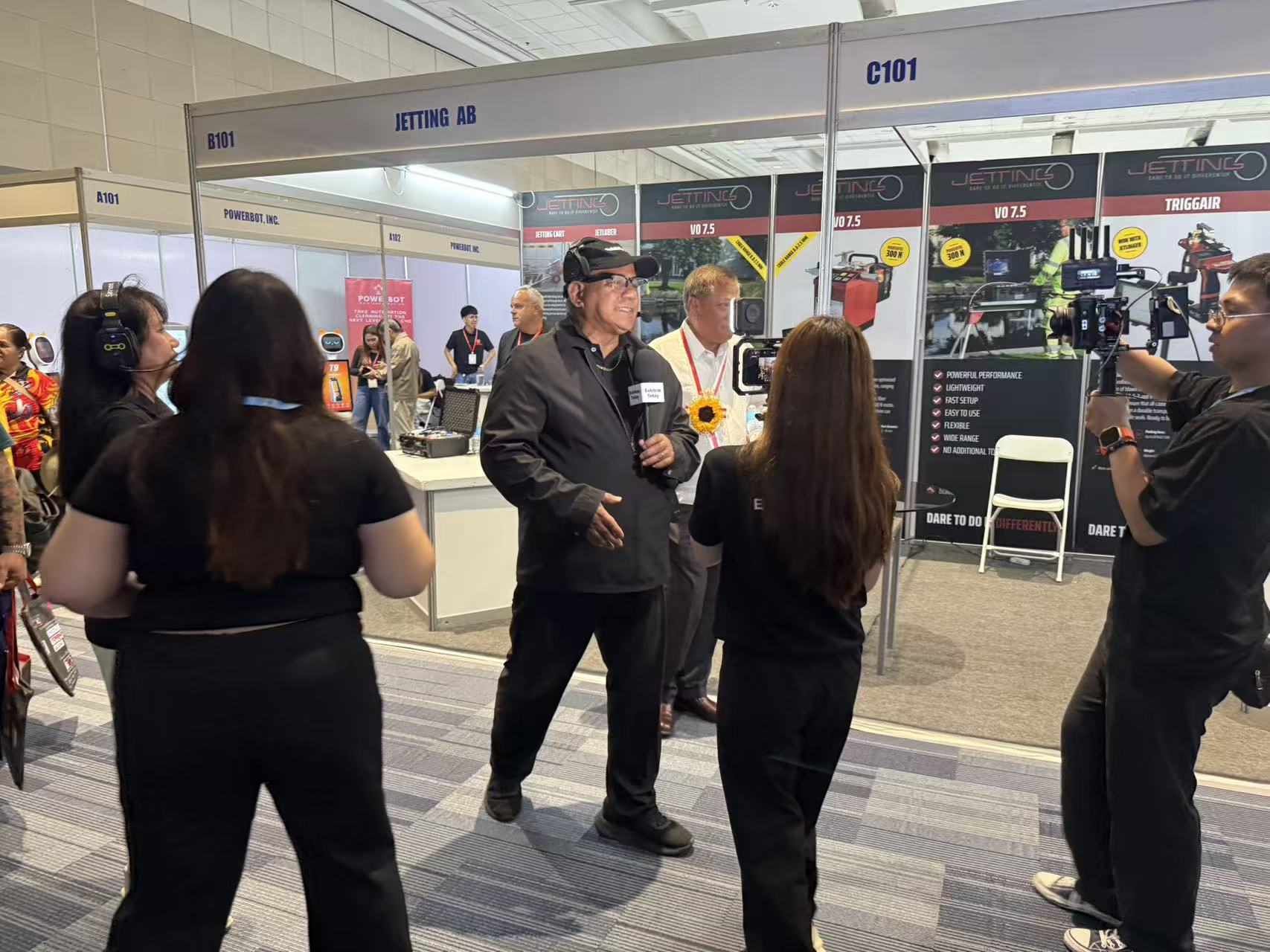 Business conversation at an exhibitor booth during Philippines 2026