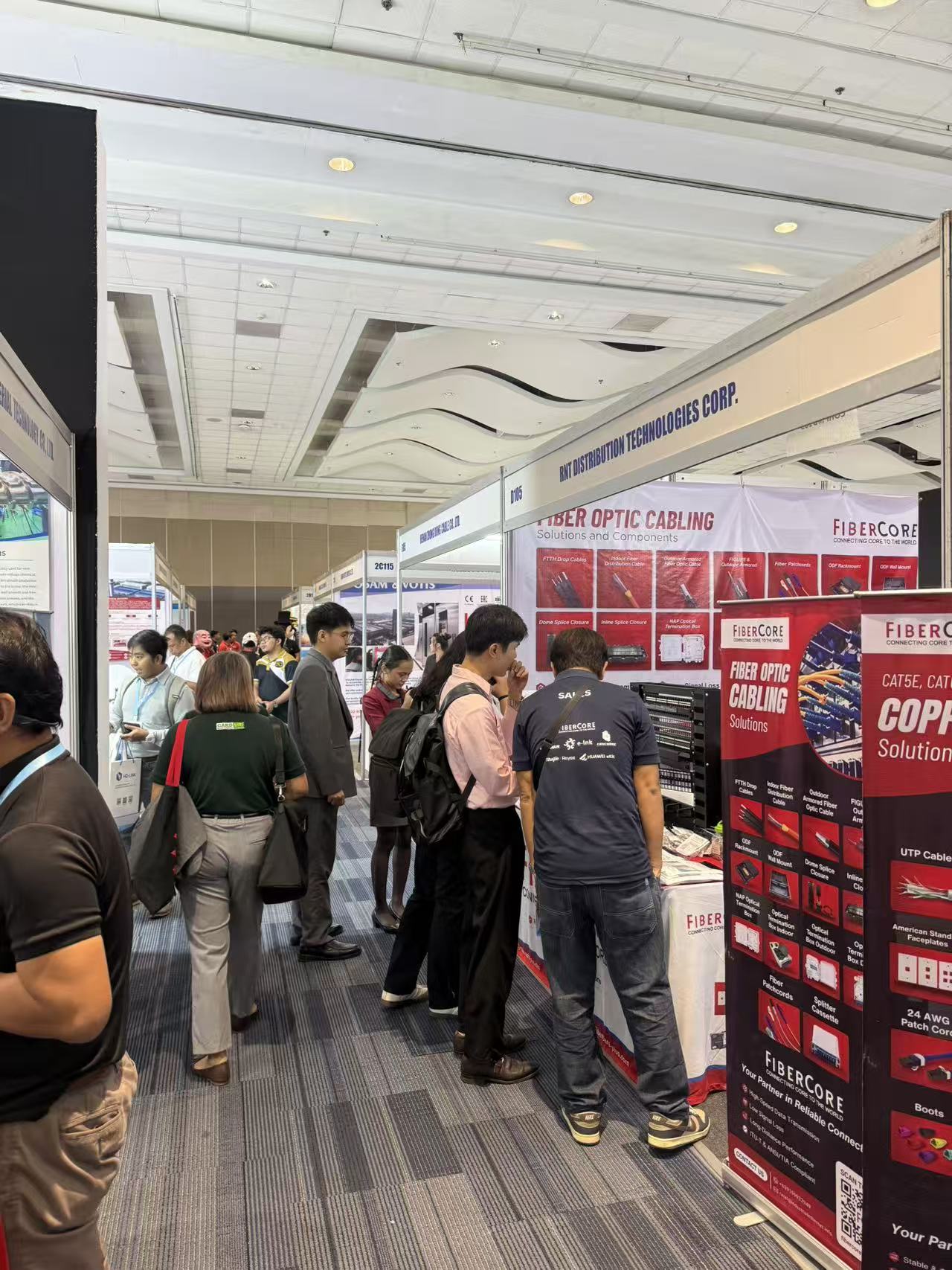 Professional visitors exploring optical fiber exhibits at Philippines 2026